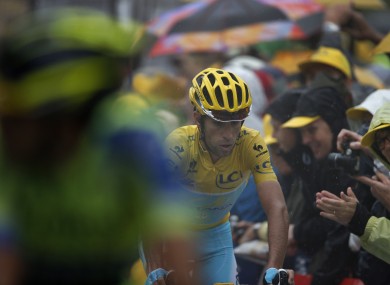 Alberto Contador, left, and Vincenzo Nibali, wearing the overall leader's yellow jersey, cross the finish line of the eighth stage.