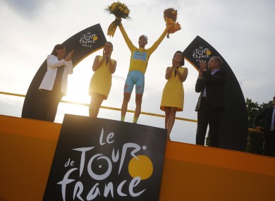 2014 Tour de France cycling race winner Italy's Vincenzo Nibali, wearing the overall leader's yellow jersey, celebrates on the podium in Paris.