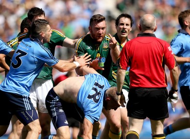 Mickey Burke brandishes a finger on his left hand to the match officials.