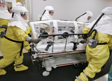 File photo: An actor-patient, made up to look as if he is infected with smallpox, is wheeled in an isolation pod during a drill at the Nebraska biocontainment unit in October 2006.