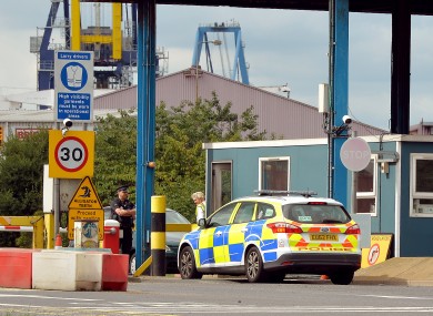 A police car arrives at the main entrance to Tilbury Docks in Essex.