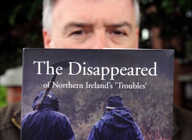 Kieran Megraw, brother of one of the Disappeared, Brendan Megraw with a book about the families' experiences.