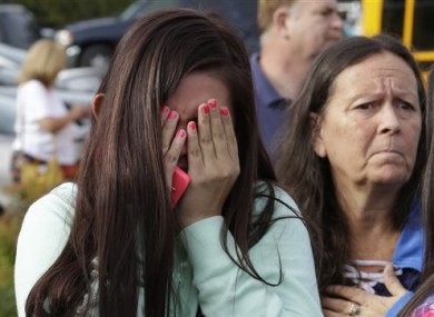 People react as they wait at a church, yesterday where students were taken to be reunited with parents following a shooting at Marysville Pilchuck High School