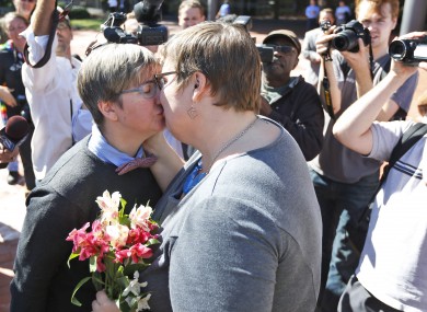 Nicole Pries and Lindsey Oliver share a kiss as they celebrate being one of the first same-sex couples in Virginia to marry.