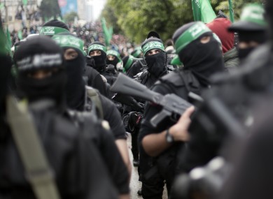Palestinian Hamas masked gunmen display their military skills during a rally to commemorate the 27th anniversary of the Hamas militant group earlier this week.
