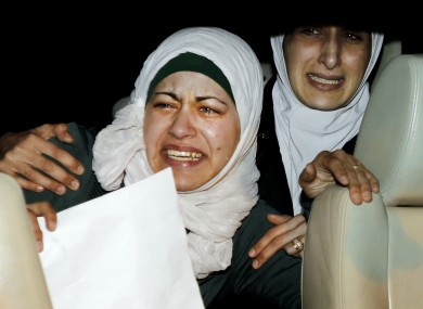 The sister, right, and wife, left, of Jordanian pilot, Lt. Muath al-Kaseasbeh, who is held by the Islamic State group militants.