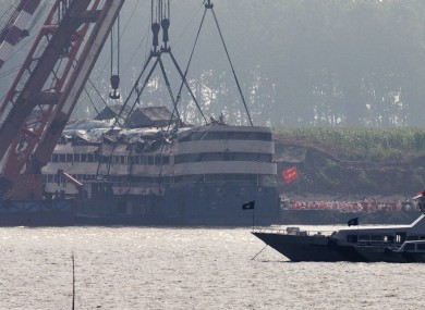 Medical workers prepare to get into the capsized Eastern Star ship after being lifted by cranes on the Yangtze River