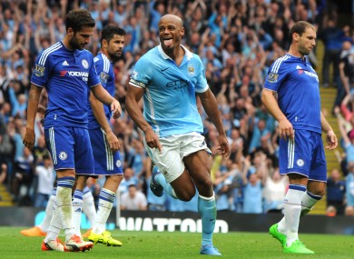 Surrounded by dejected Chelsea players, Man City captain Vincent Kompany celebrates his goal yesterday.