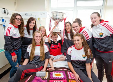 The Cork ladies footballers visited Crumlin's Childrens Hospital this morning with the Brendan Martin Cup.