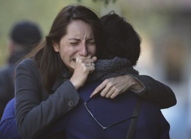 A woman cries as relatives and friends wait for victims to be identified following last week's nightclub fire.
