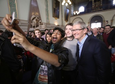 Apple CEO Tim Cook poses for selfies with students at Trinity College in November 2015.