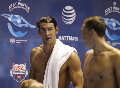 Michael Phelps, left, talks with another swimmer after the men's 100 metre butterfly during a preliminary race in the US Winter Nationals.