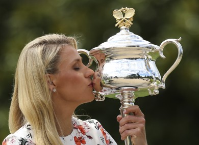Angelique Kerber kisses her Australian Open trophy the day after winning it.