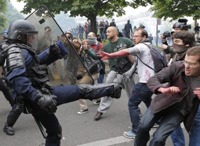 Riot police officers clash with protestors during yesterday's demonstrations.