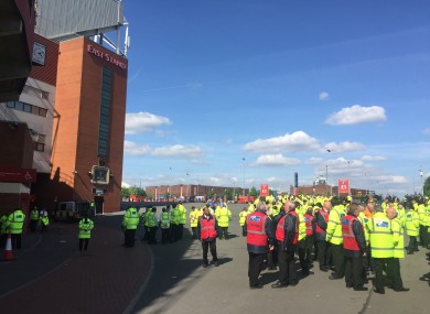 Old Trafford stewards wait outside after the stadium was completely evacuated.