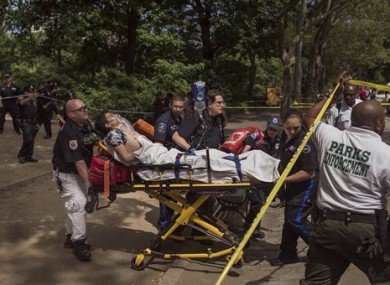 An injured man is carried to an ambulance in Central Park in New York yesterday following an explosion.