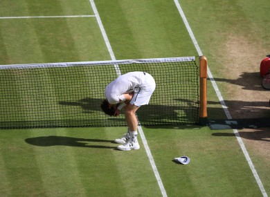 Andy Murray celebrates winning the Men's Singles trophy on day thirteen of the Wimbledon Championships.