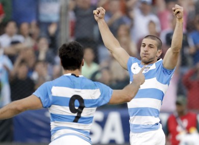 Argentina's Los Pumas Tomas Cubelli, right, and Martin Landajo celebrate after defeating South Africa 26-24.