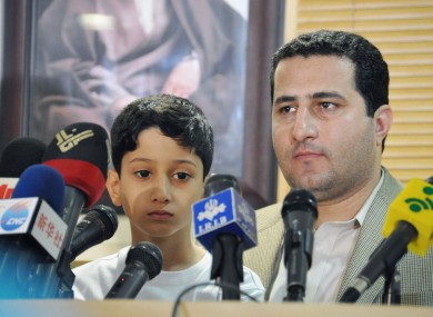Iranian scientist Shahram Amiri (R), who went missing in 2009, attends a press conference with his son next to him, at Imam Khomeini International Airport in Iran in 2010.