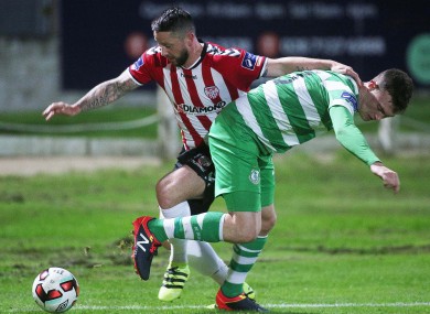 Derry City's Rory Patterson and Sean Heaney of Shamrock Rovers battle for possession.