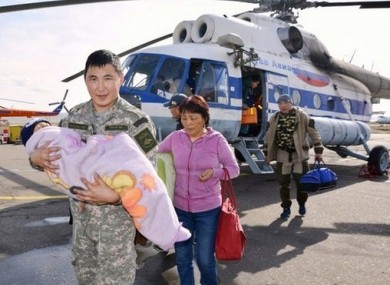 Three-year-old Tserin Dopchut in the arms of a local rescue worker.