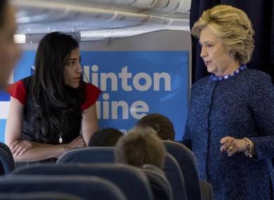 File photo of Democratic presidential candidate Hillary Clinton speaking with senior aide Huma Abedin.