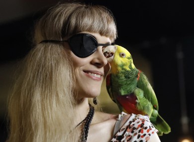 Karen Pease a supporter of the Pirate Party arrives with her parrot named Mal at the Pirate Party election party in Reykjavik, Iceland.