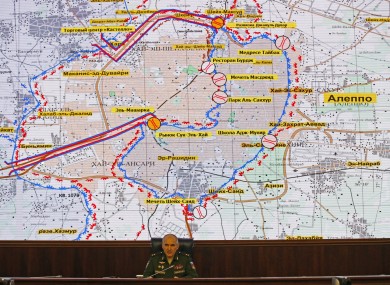 Lt. Gen. Sergei Rudskoi of Russia's military on front of a map of Aleppo.