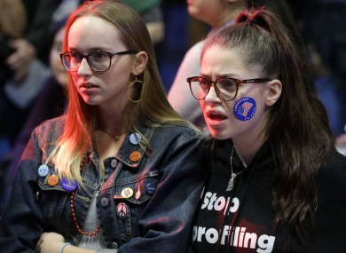Emma Finnamore, of Maplewood, New Jersey, left, and Rayah Naji, of Boston, right, react while watching televised election returns during a watch party at Wellesley College.