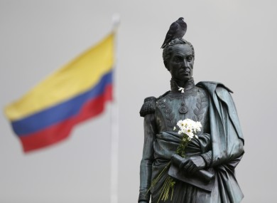 Flowers decorate the statue of independence hero Simon Bolivar in downtown Bogota, Colombia, in the days after President Juan Manuel Santos won the Nobel Peace Prize following the voters' narrow rejection of a peace deal with FARC.