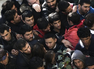 Migrants and refugees crowd in a line as they wait for their registration in Berlin, Germany, Thursday, Oct. 1, 2015.