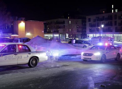 Police survey the scene following the shooting in Quebec City, Canada.