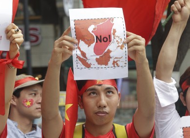 A Vietnamese protester showing a map marked
