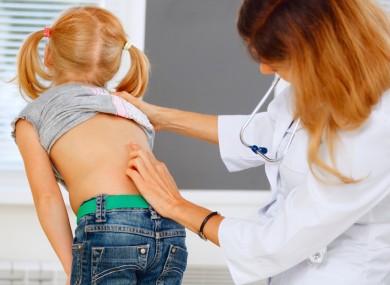 Child being checked for scoliosis.