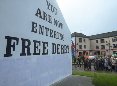 The coffin of Martin McGuinness is carried past Free Derry corner in his home city.