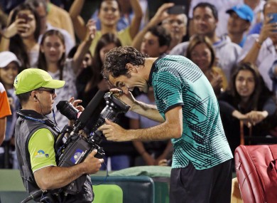 Roger Federer, of Switzerland, clowns for the camera after defeating Nick Kyrgios, of Australia, 7-6 (9) 6-7 (9) 7-6 (5) in a tennis match at the Miami Open.