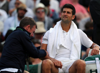 Djokovic receives treatment before retiring from Wimbledon.
