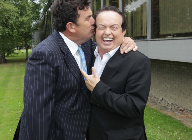 Presenter Des Cahill kisses his colleague Marty Morrissey.