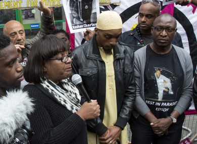 The father of Rashan Charles (middle) at a vigil for his son last weekend.