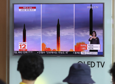 People watch a news report about North Korea's missile launch at Seoul Train Station in Seoul, South Korea.