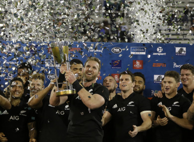 Kieran Read holds up the trophy.