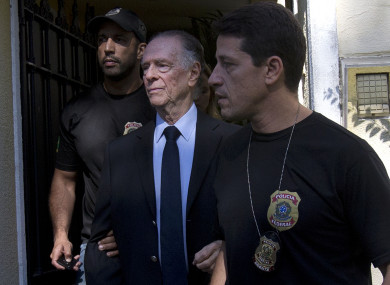 Carlos Nuzman, President of the Brazilian Olympic Committee, center, is escorted by federal police officers