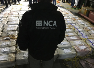 An NCA officer surveying the cocaine haul