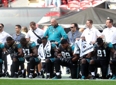 Jacksonville Jaguars players kneel in protest during the national anthem.