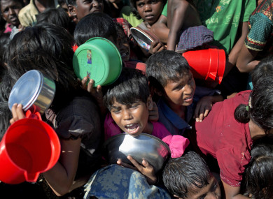 Rohingya children fighting to receive food handouts at a refugee camp in Ukhiya, Bangladesh.