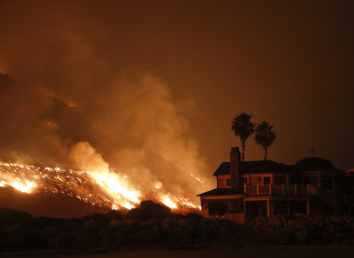 A wildfire threatens homes as it burns along the 101 Freeway in Ventura, California.