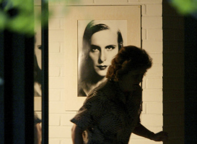 A housekeeper, who refused to be identified, passes by a picture of famous film director Leni Riefenstahl on the wall in Riefenstahl's home in Poecking, south of Munich, on Tuesday, Sept. 9, 2003.