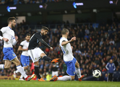 Argentina's Ever Banega, centre, scores his side's first goal during the international friendly.
