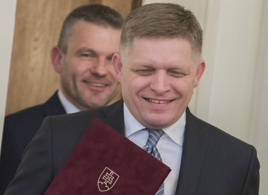 Outgoing Slovak Prime Minister Robert Fico (front) and his successor Peter Pellegrini arrive for the ceremony of tendering resignation by Fico and appointing Pellegrini for the post, in Bratislava, Slovakia.