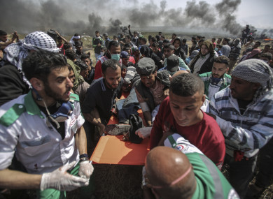 Protesters carrying an injured man.